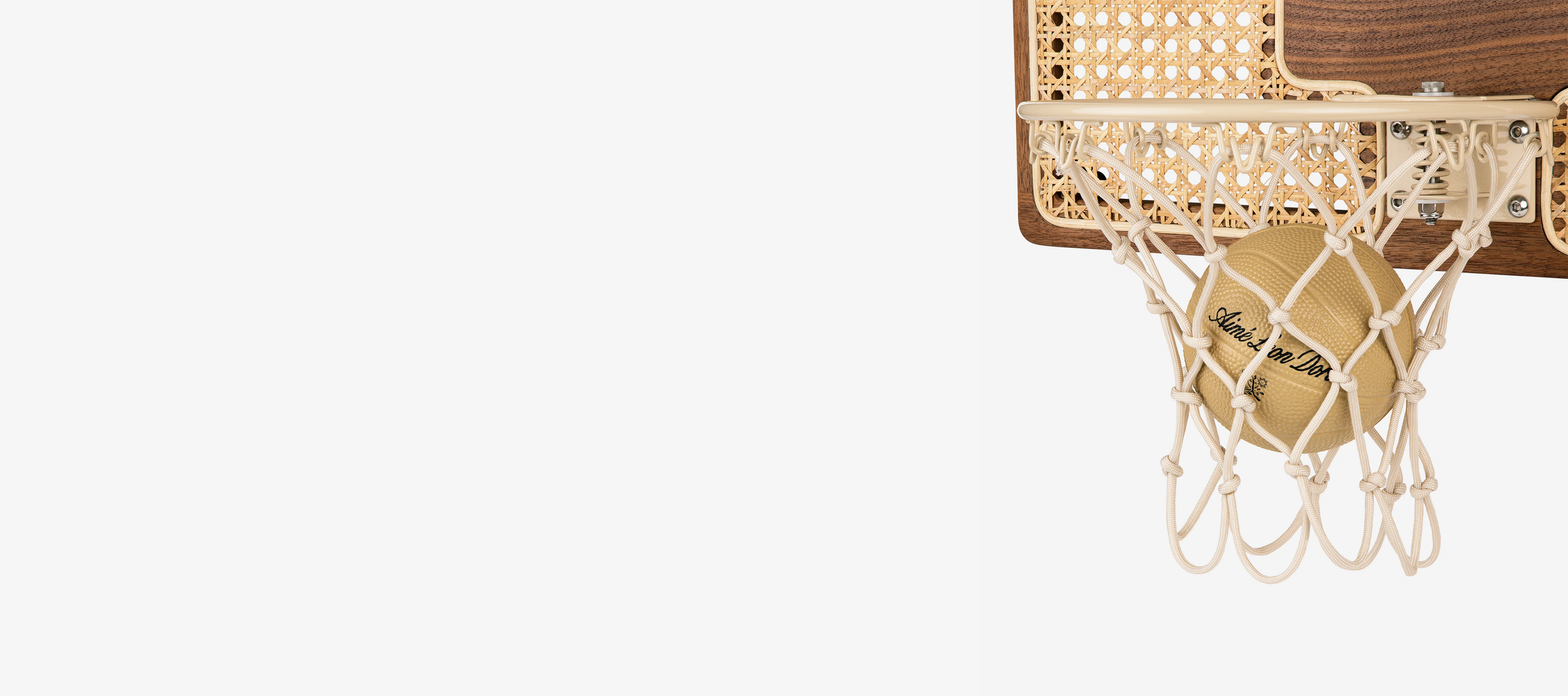 Detail of custom rim and hardware on Aimé Leon Dore walnut and rattan mini hoop collaboration.