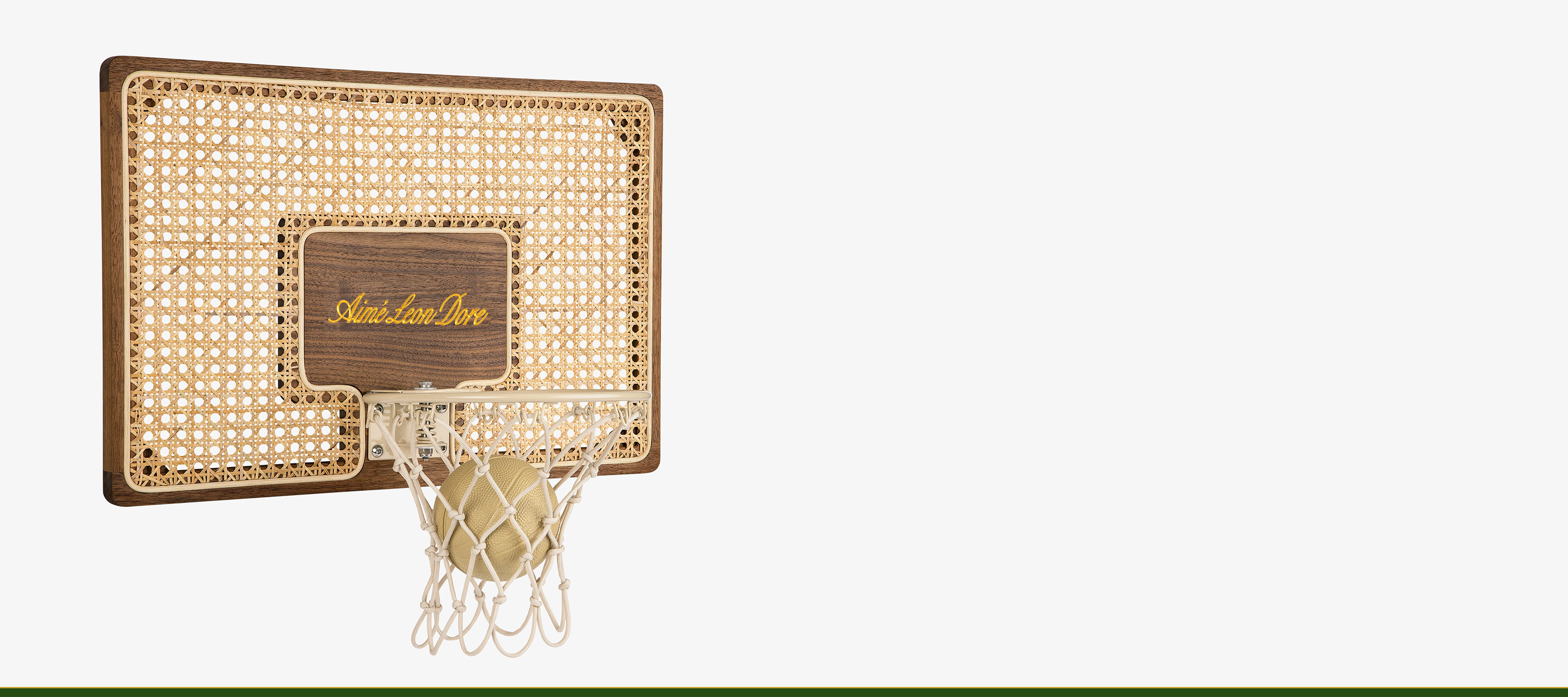 Aimé Leon Dore collaboration mini hoop installed in modern interior, combining walnut, rattan, and refined sport-inspired design.
