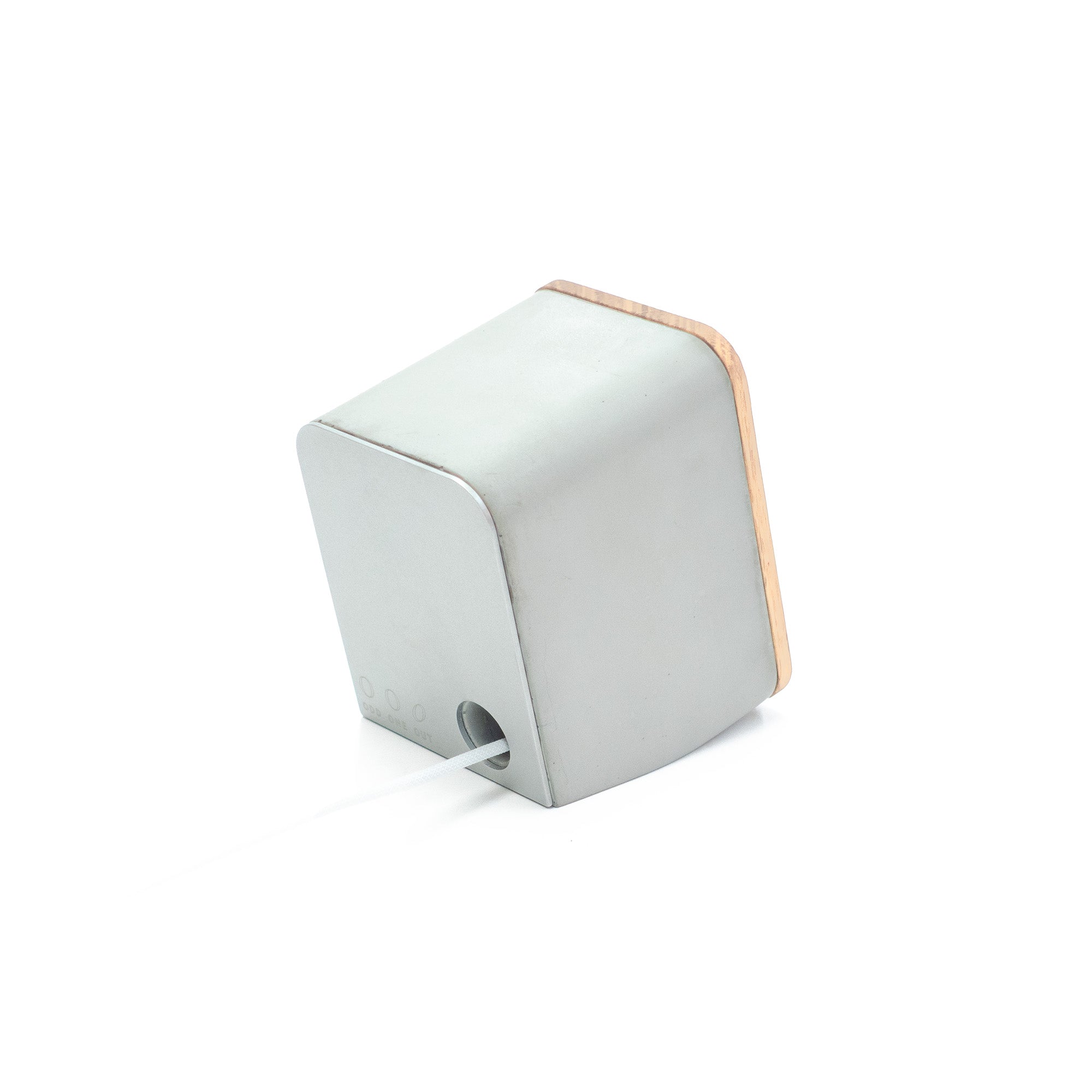 Angled rear view of architectural concrete and white oak AirPods Pro charging dock designed for minimalist desk environments.