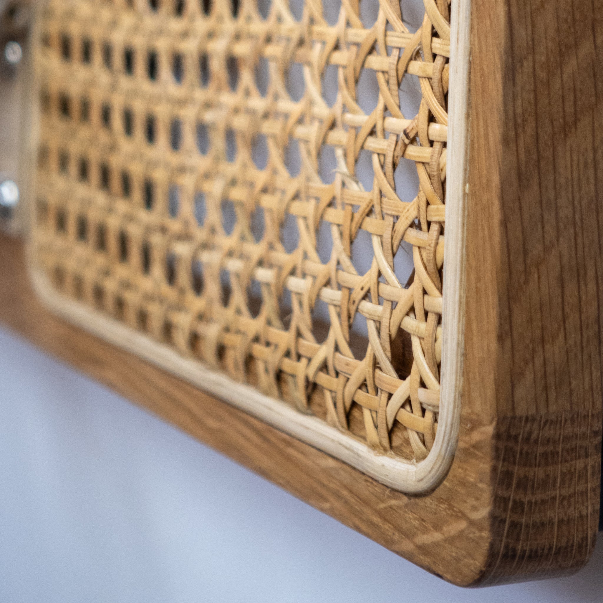 detail shot of a wallmounted mini hoop made with rattan and white oak