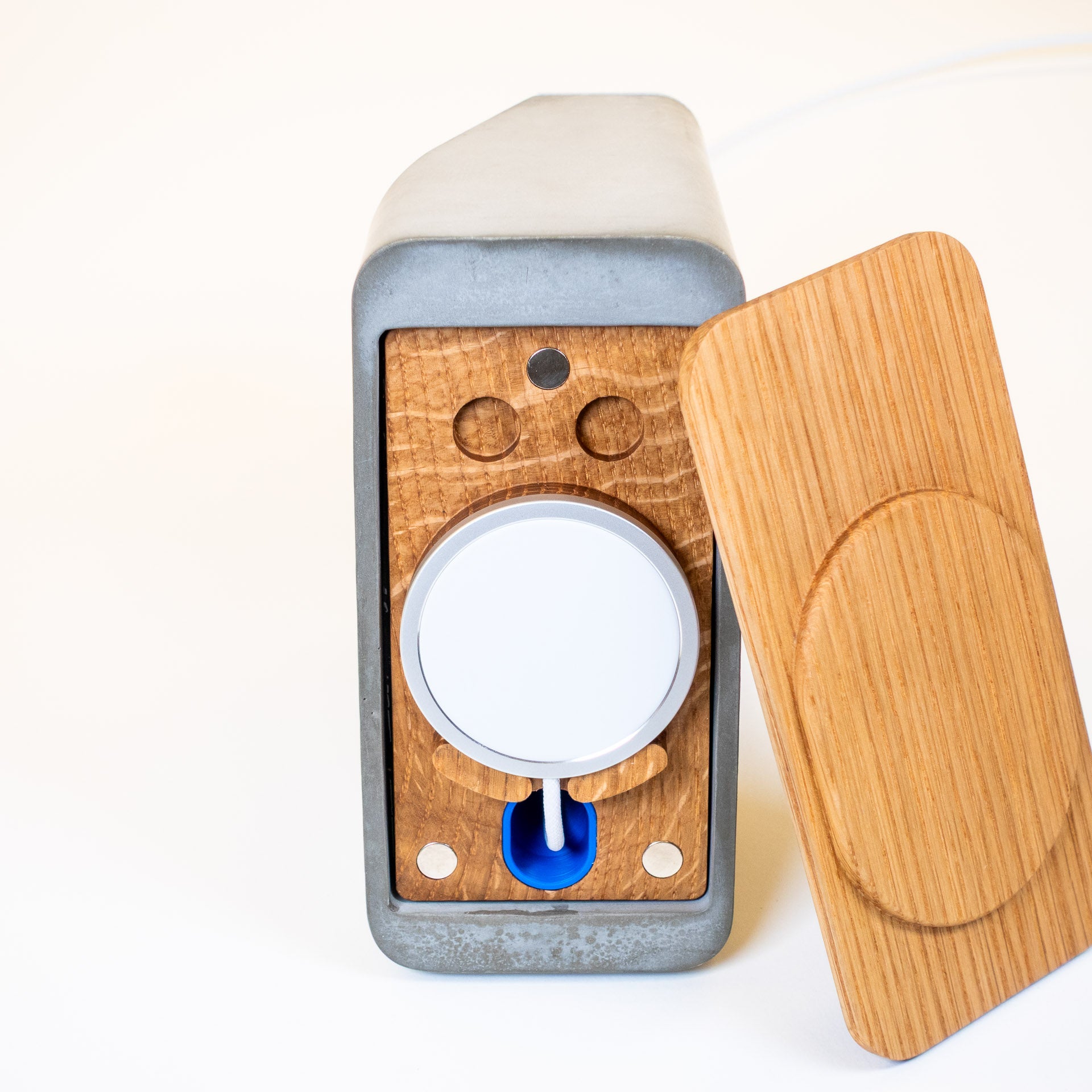 Close-up detail of concrete and white oak MagSafe charger showing clean craftsmanship