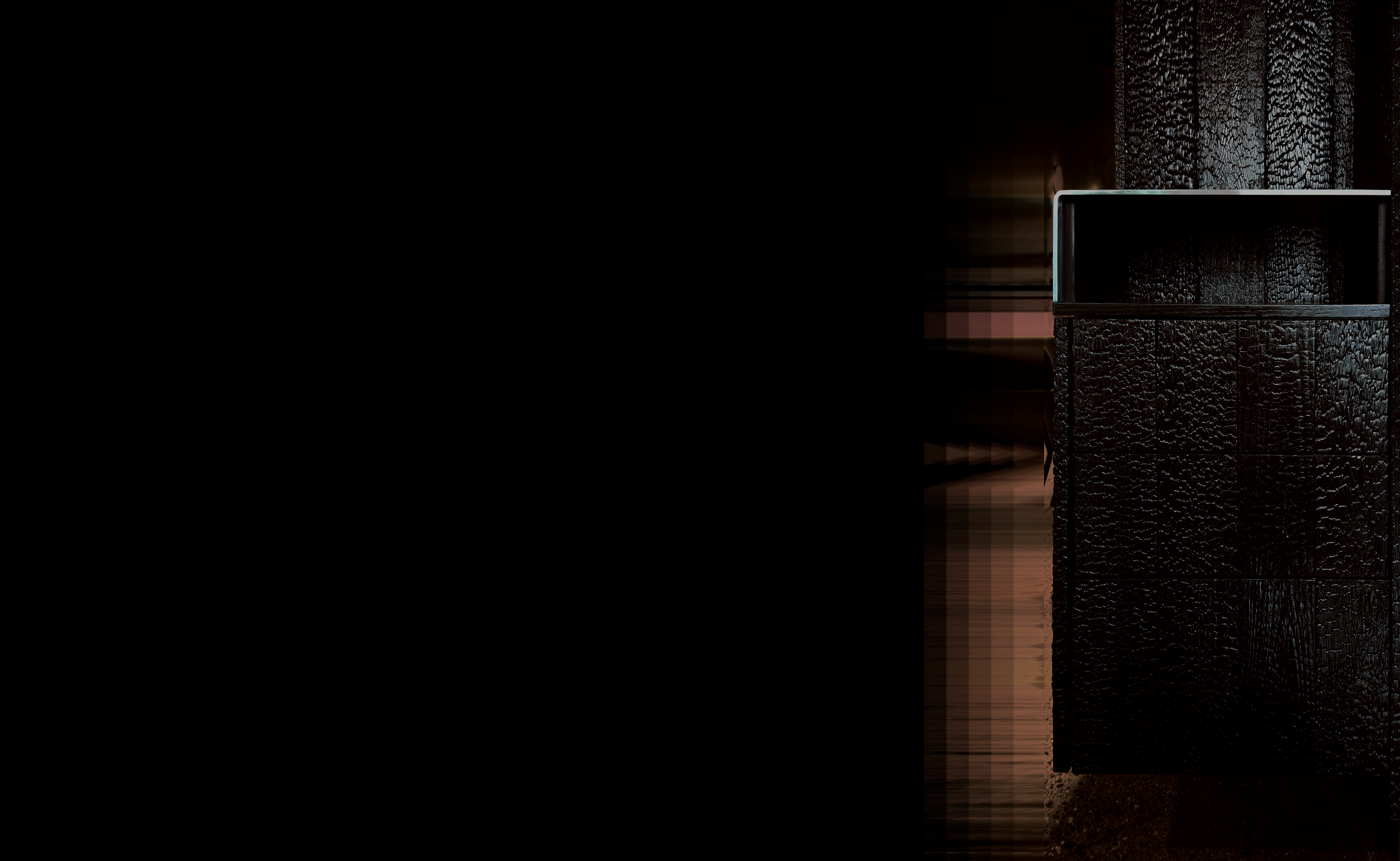 Straight-on front view of custom Shou Sugi Ban server station furniture with stainless steel cubby top and base kick, designed as restaurant millwork installation.