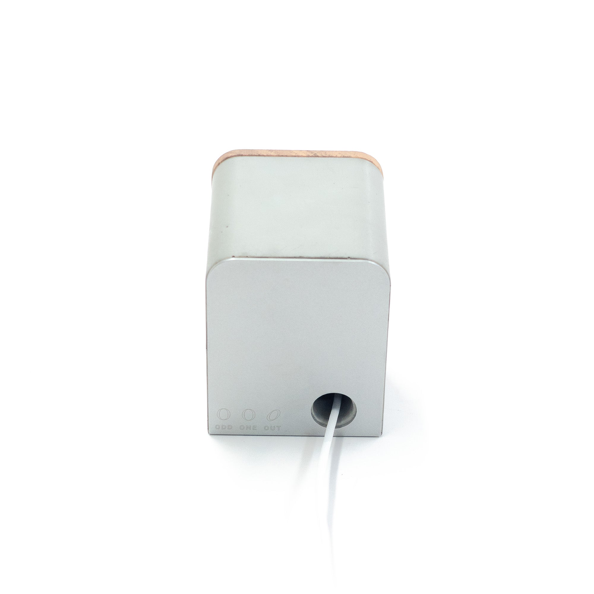 Rear view of concrete AirPods Pro MagSafe charging stand with concealed cable routing and solid concrete block construction.