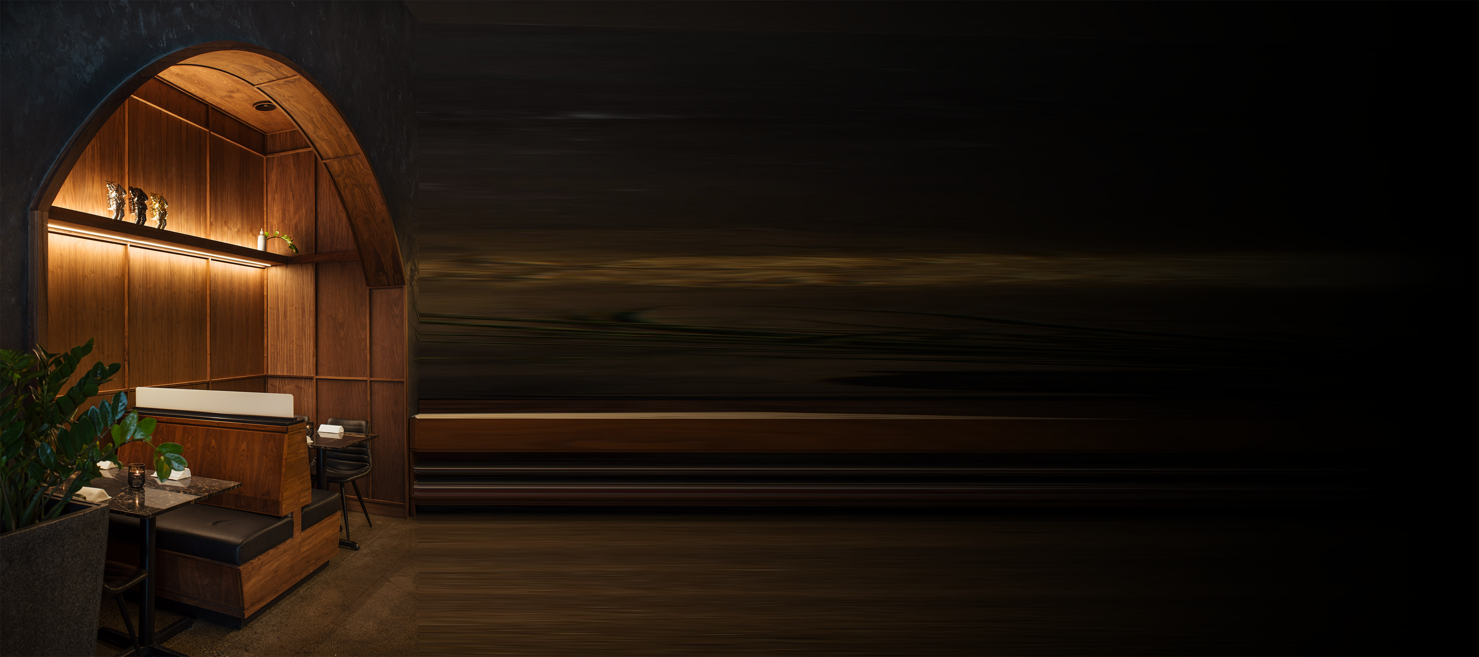 Walnut alcove with defined arch, vertical ribbed panel detailing, and recessed LED lighting above built-in banquette seating at AnnaLena.