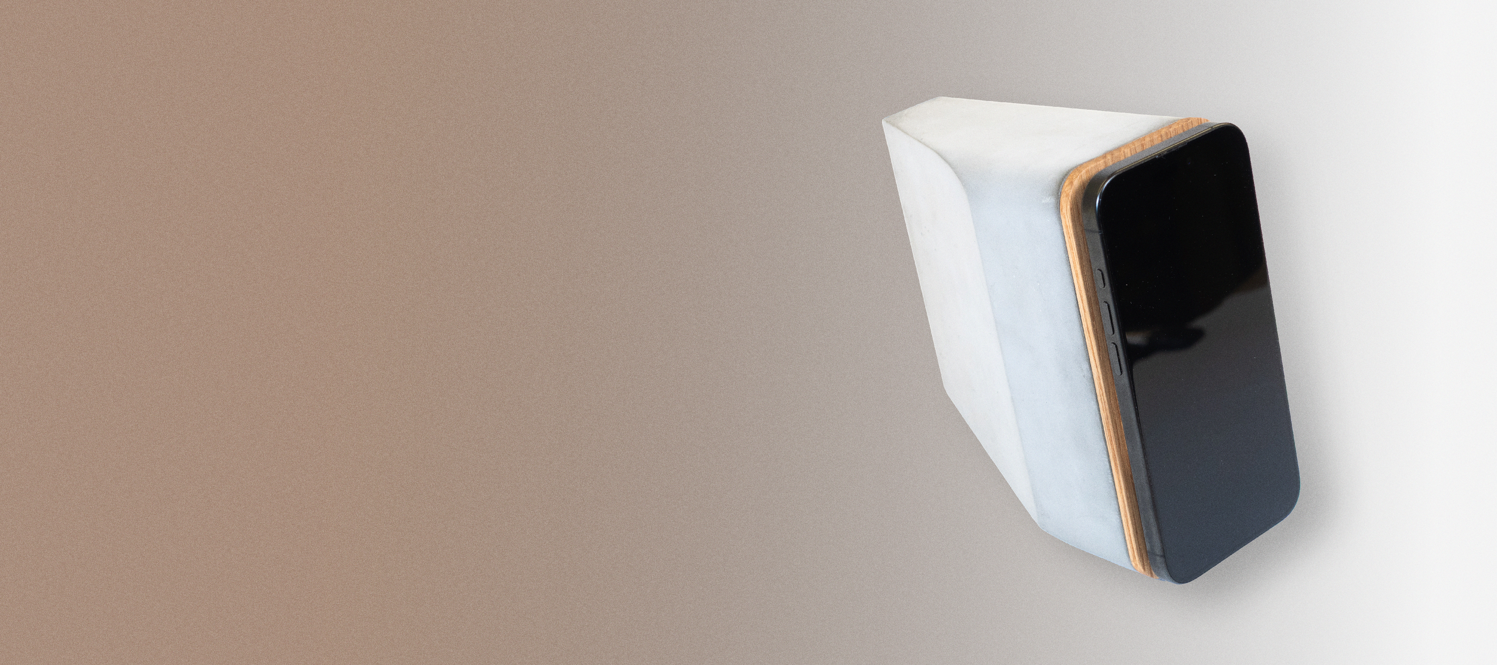 White oak and concrete MagSafe iPhone charger with brutalist design, combining solid concrete base and white oak detail in a modern Japandi-inspired workspace.
