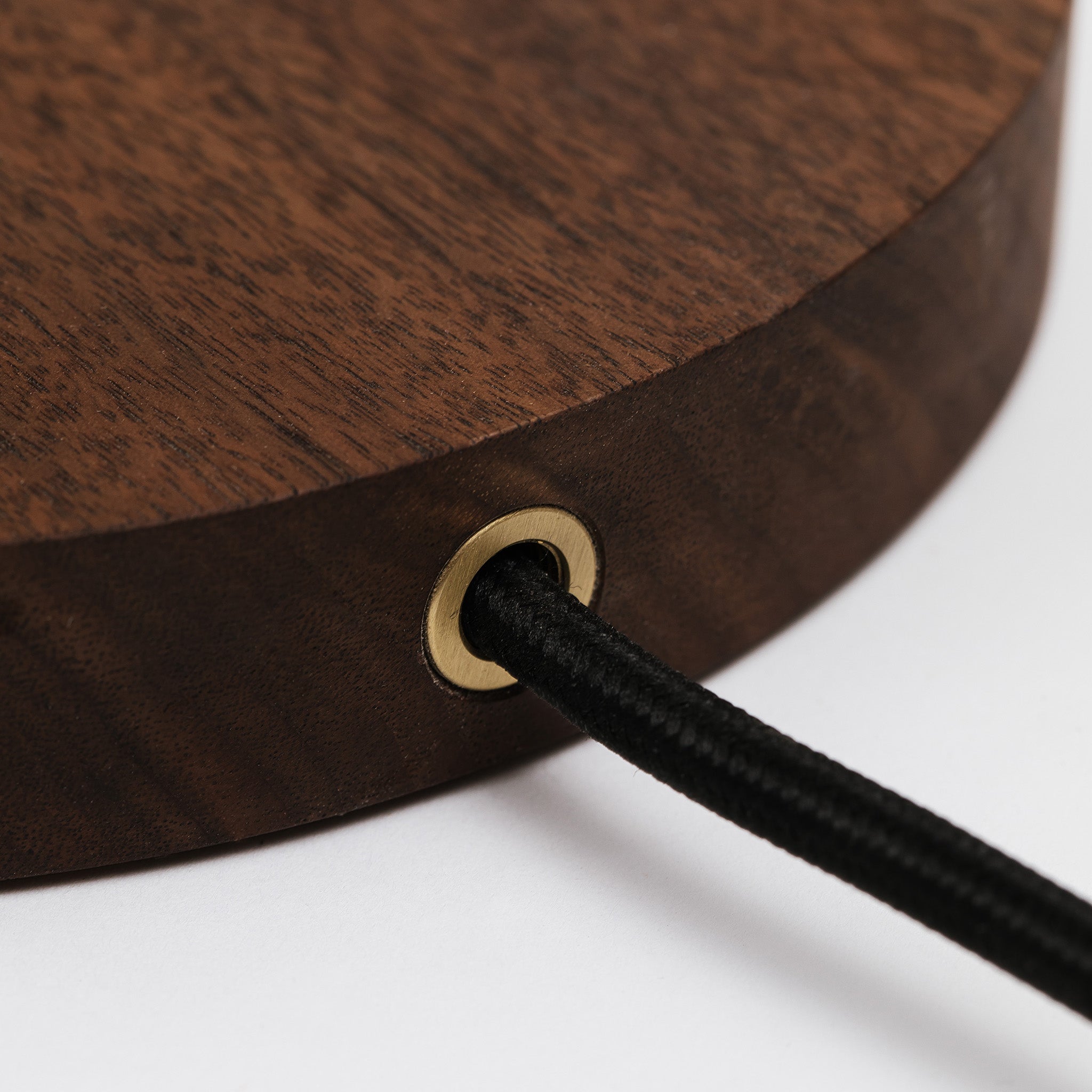 Black cloth wrapped cord at the rear of the table lamp -walnut