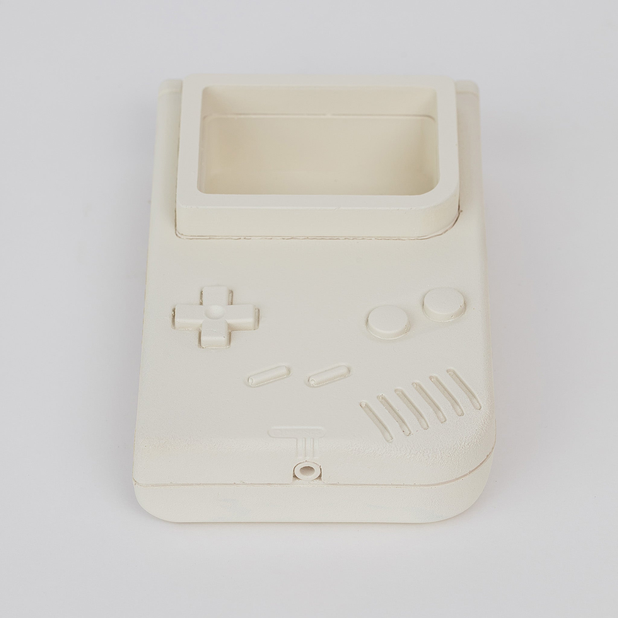 Front view of stone casted classic Nintendo gameboy game console catch-all